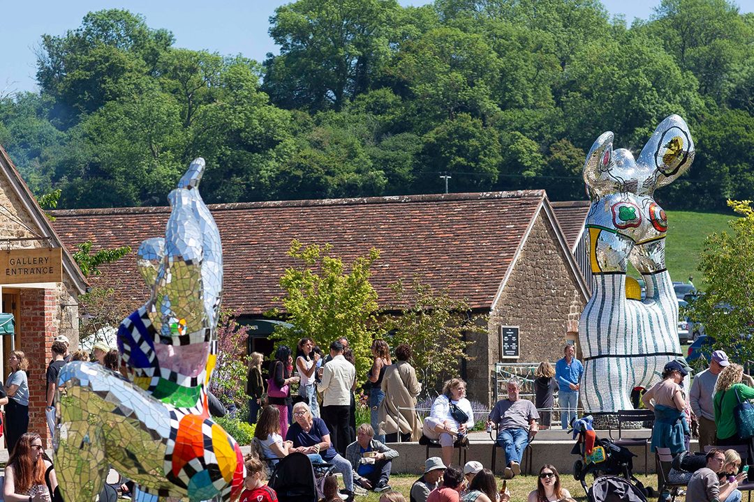 Crowds gathered on the lawn among sculptures outside the gallery at Hauser & Wirth Somerset